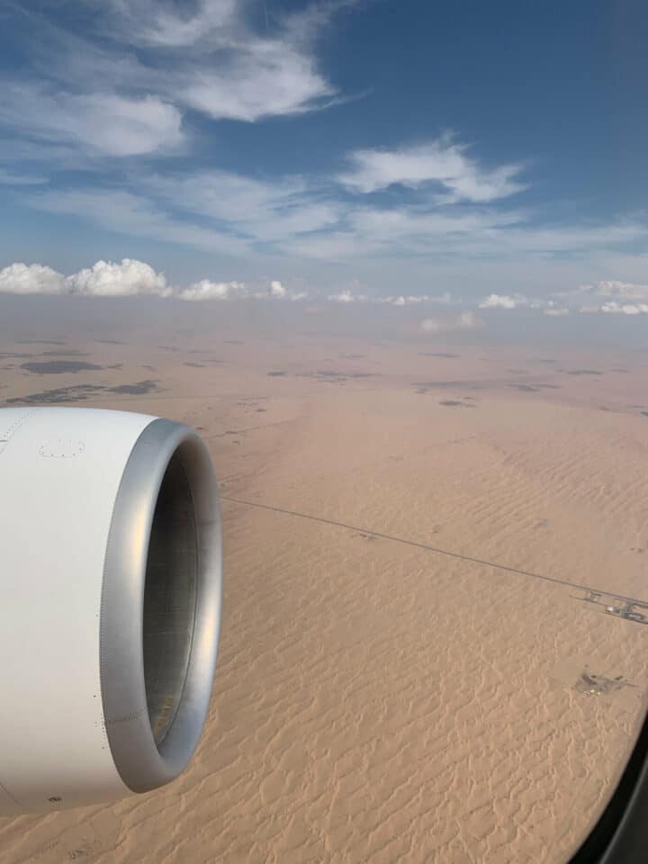 A desert is split by a road and the sound of the jet turbine